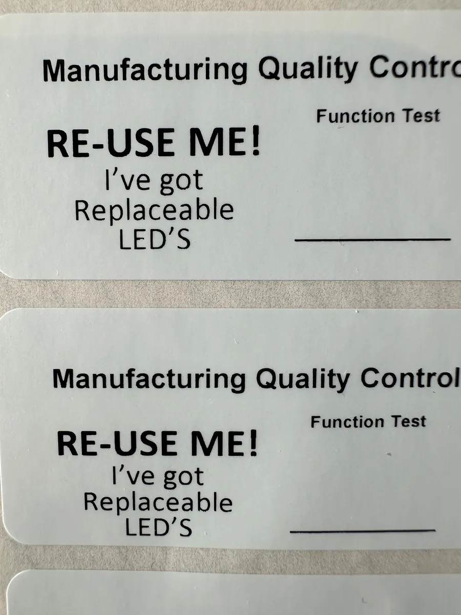 Two manufacturing quality control labels on a luminaire, each printed RE-USE ME! I've got replaceable LEDs, with a blank line beside Function Test for a signature.